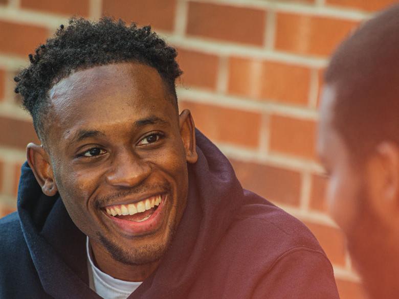 male student laughing.